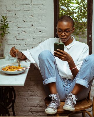 Eating holding cell phone